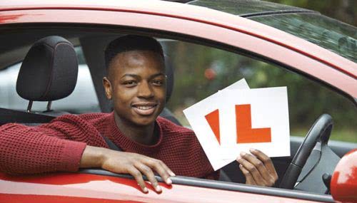 Person sitting in a car with L-plates